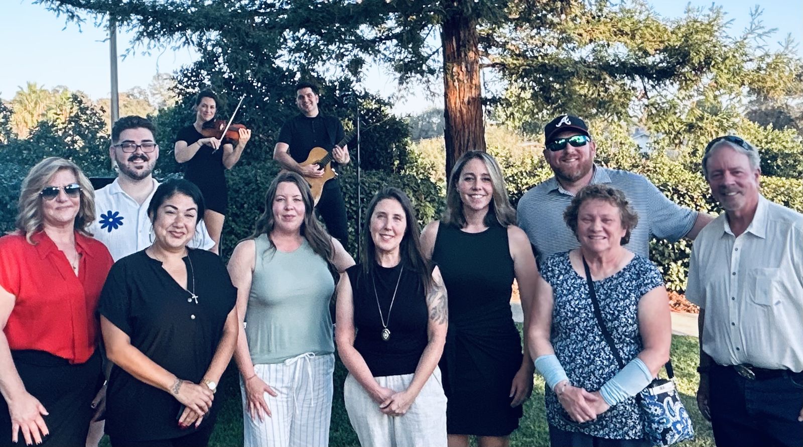 Guests and the Nightingale team gathered together under the trees at golden hour.